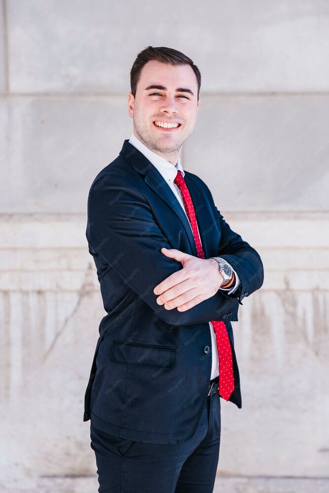 Matt Holland smiling, arms folded, outside his office in Glens Falls