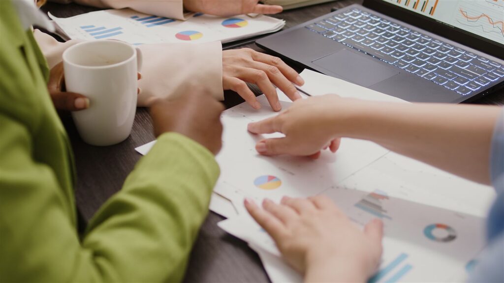 Colleagues analyzing data and documents in a boardroom