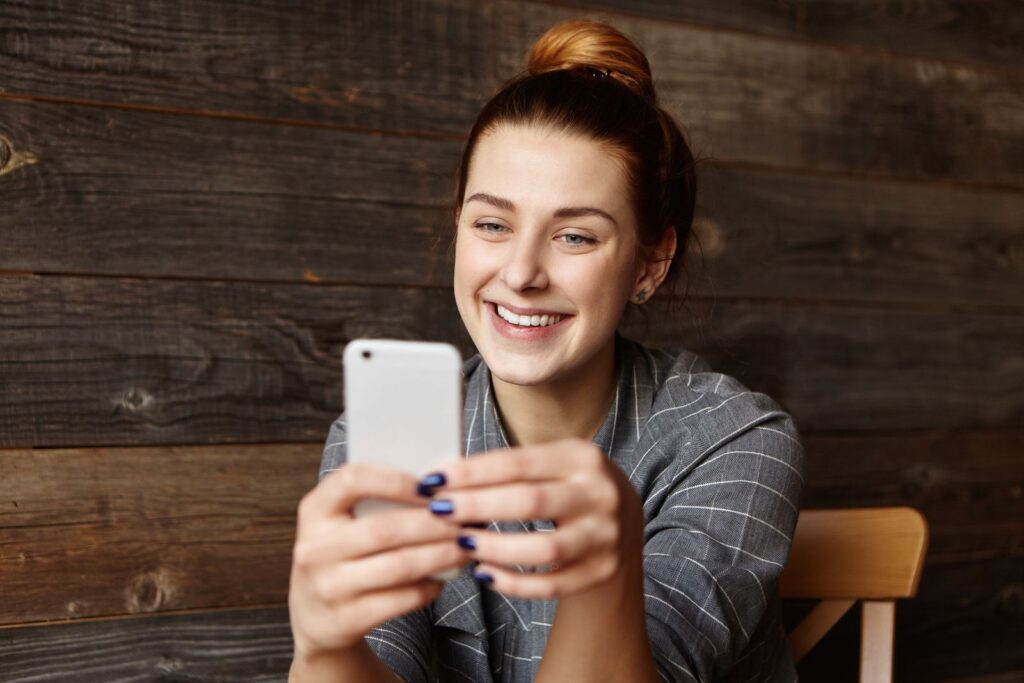 Customer smiling while reading a text message